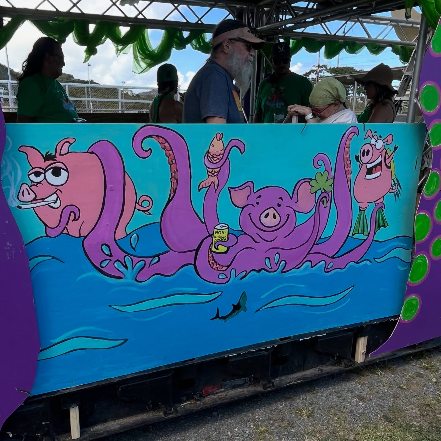 Parade float panel with a pig-octopus hybrid drinking beer in an underwater scene